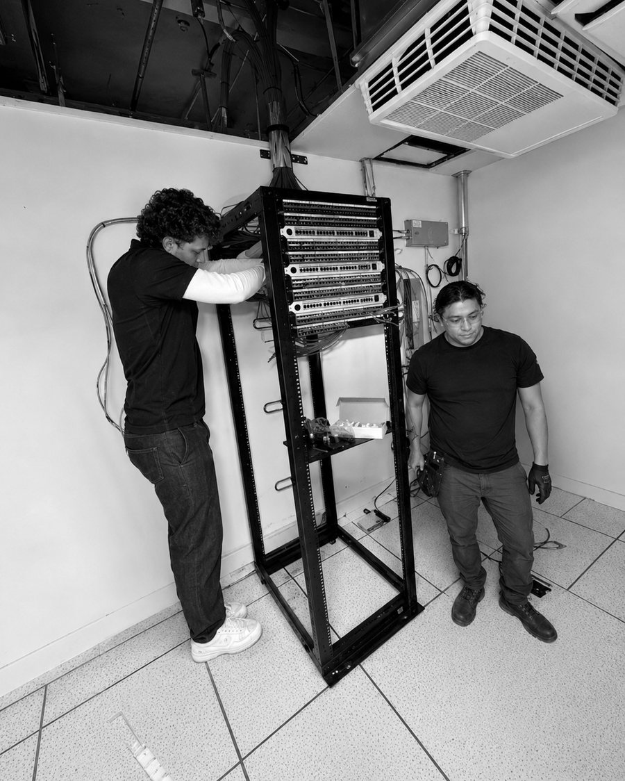 Two iMS technicians terminating a patch panel