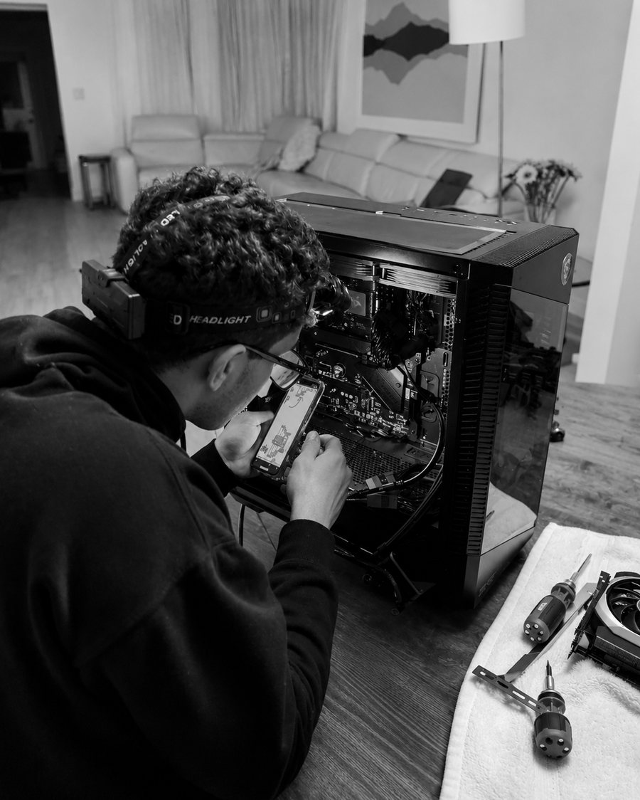 A technician working inside a desktop workstation